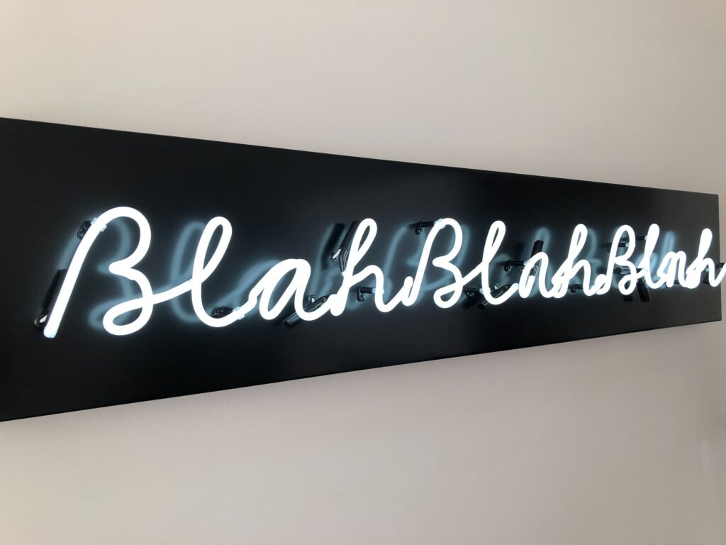 A wall neon sign saying BlahBlahBlah representing slang words