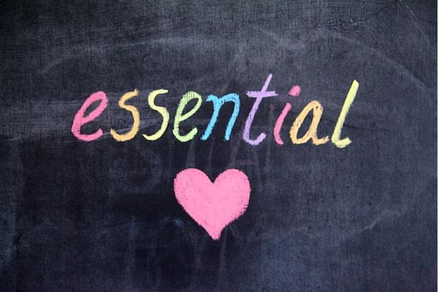 The word ”essential” and a heart on a blackboard, drawn in various colors.