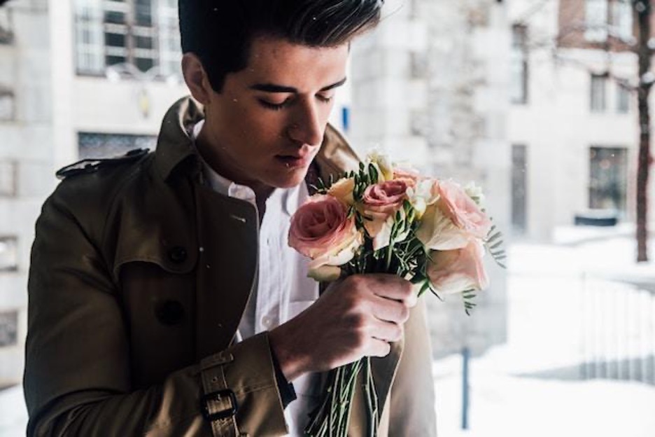 A young man with a flower bouquet
