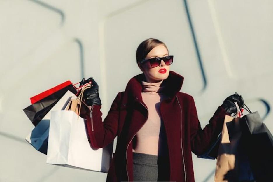 A woman holding many shopping bags.