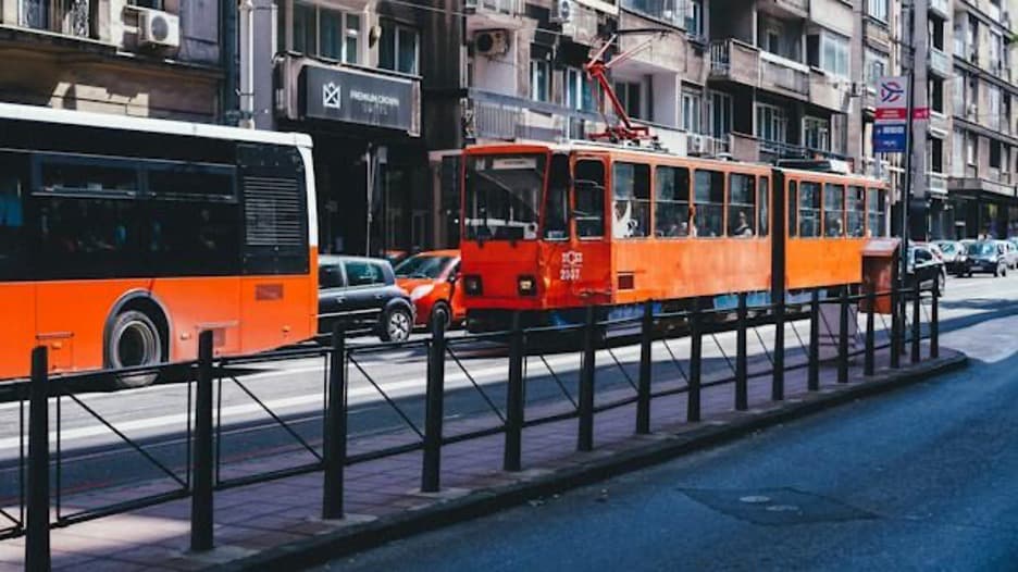 Two red trams on a street