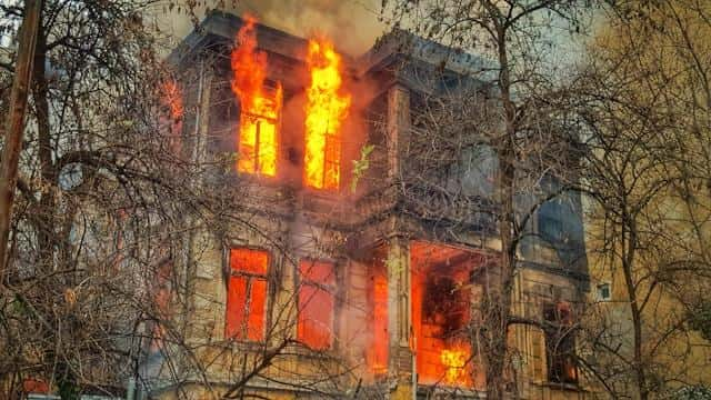 A raging fire inside a big house.