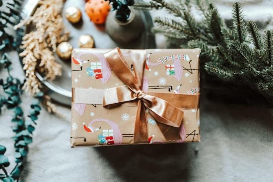 A gift box on top of Christmas decorations.