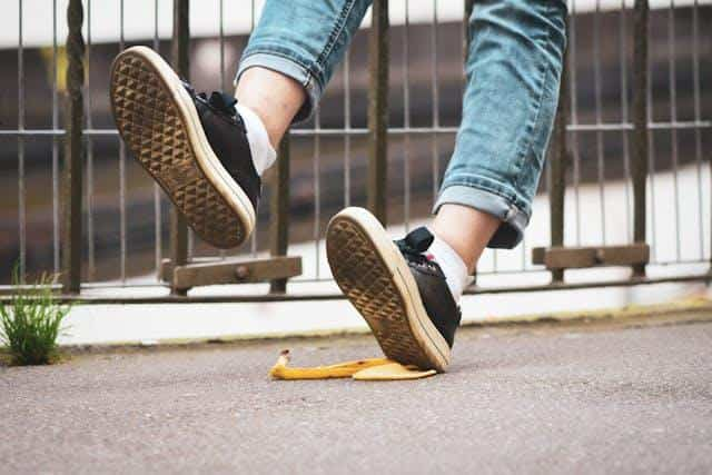 A person slipping on a banana peel.