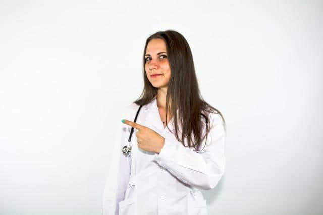 A young female doctor with a stethoscope over her shoulder, working in Serbian healthcare.