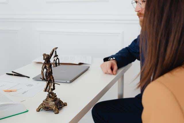 A client talking with a lawyer at an office.