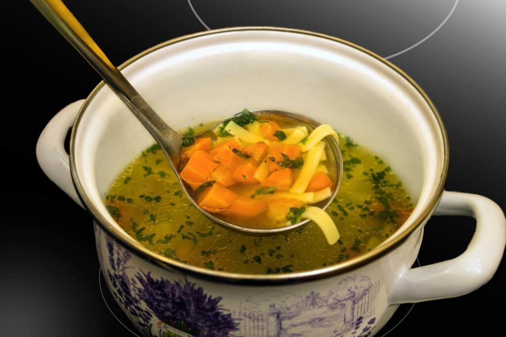 Chicken noodle soup in a ceramic pot — one of the most popular choices among Serbian soups and stews.