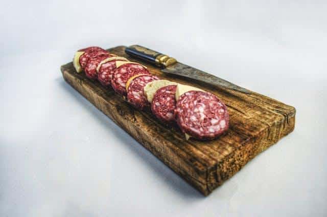 Slices of meat on a chopping board.