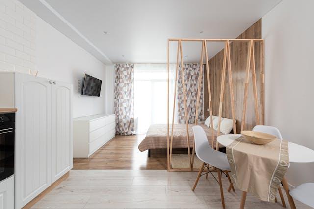 An interior of a small but bright studio apartment.