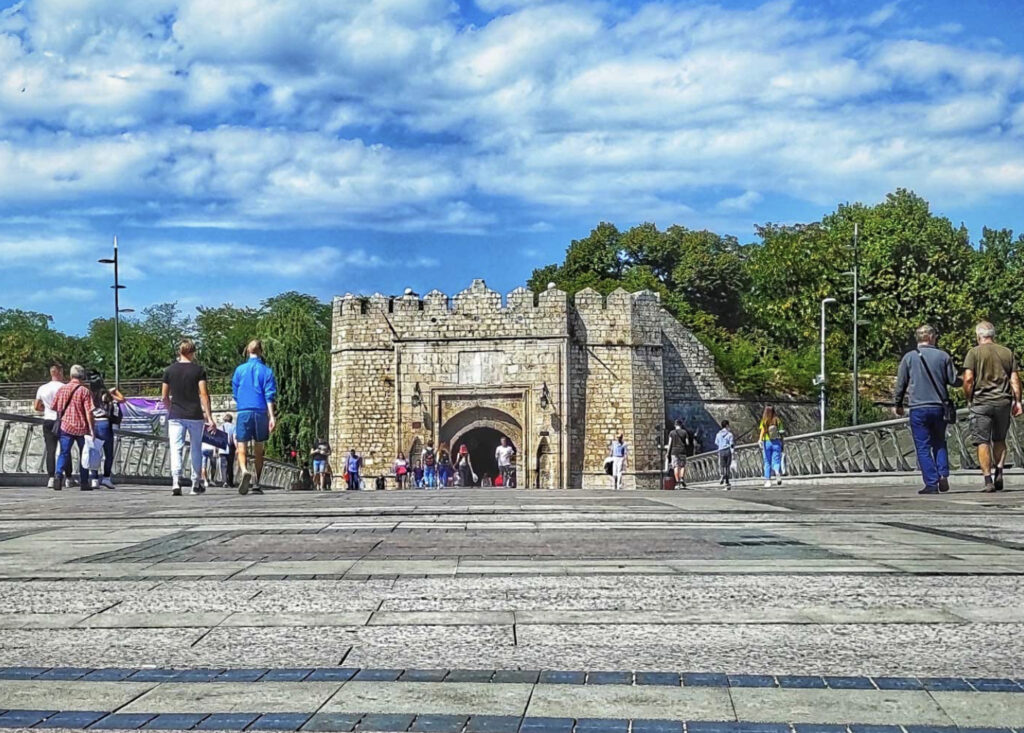 The entrance to the Niš Fortress with people walking around