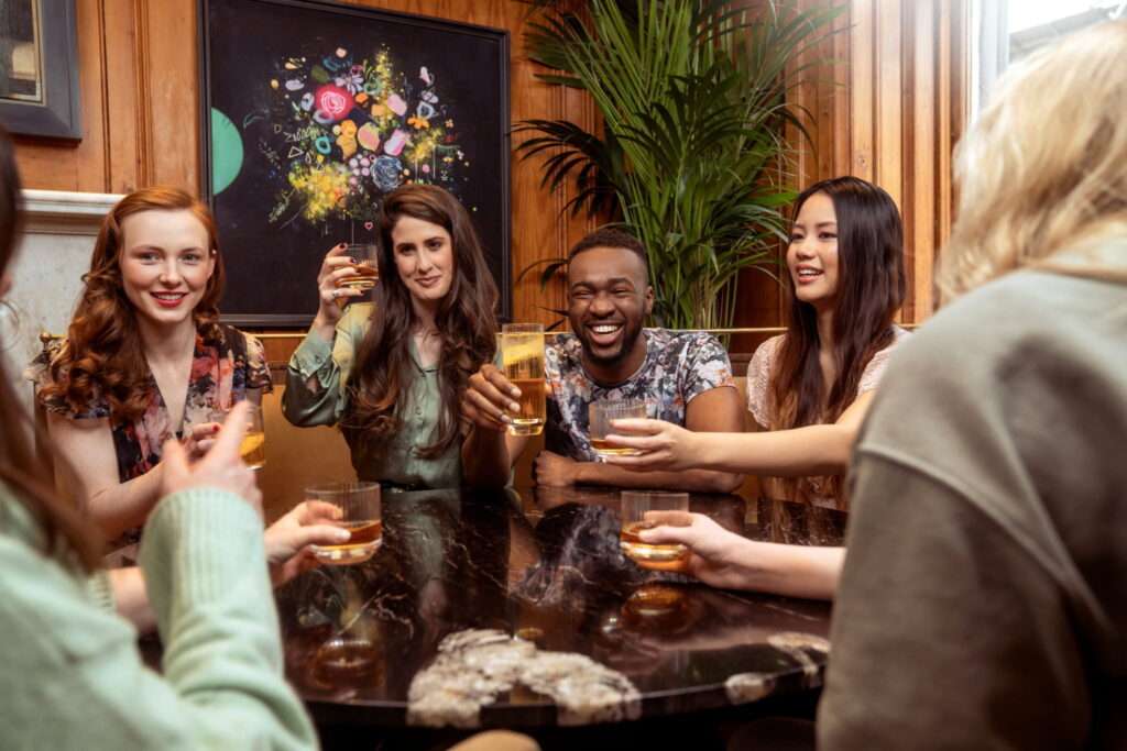 A group of friends toasting at a bar