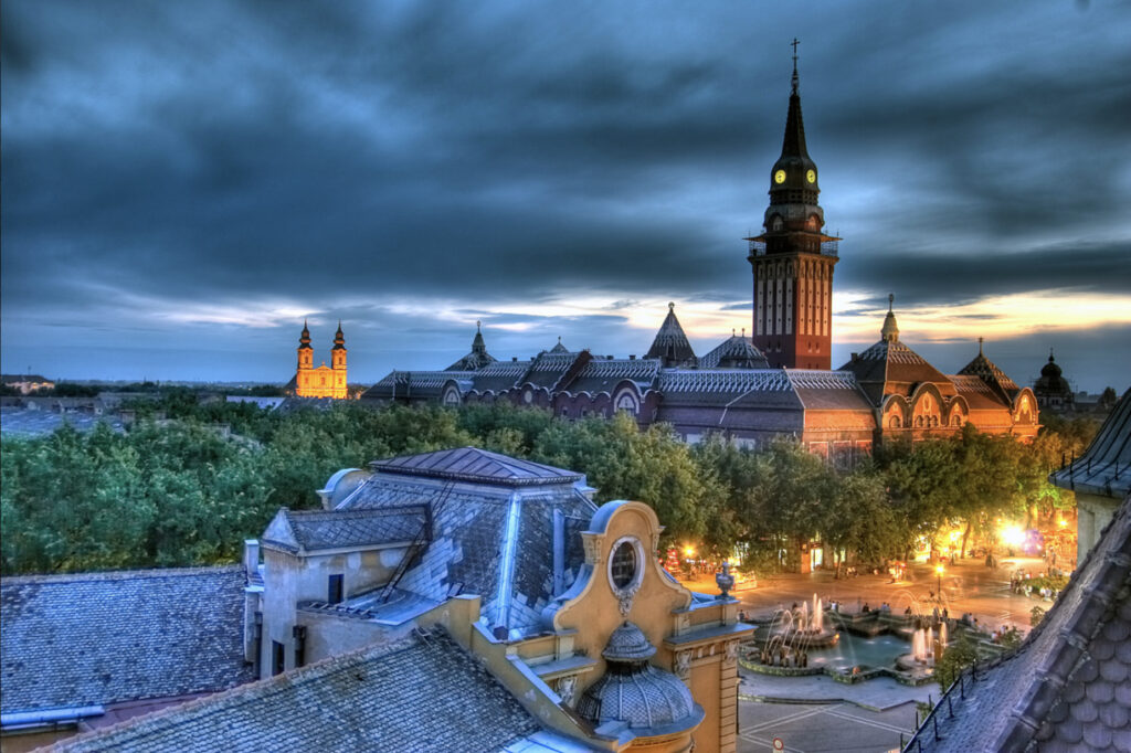 A city landscape with a cloudy sky